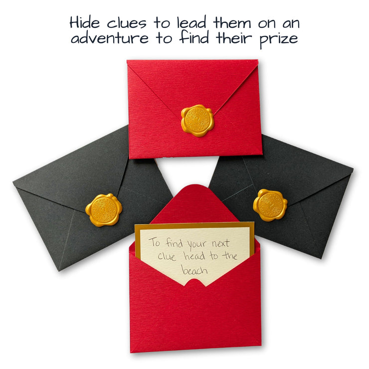 diy scavenger hunt custom clue in a wax sealed envelope that says "to find your next clue head to the beach"